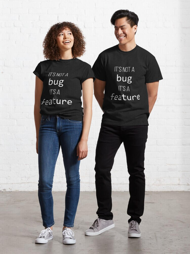 A man and a woman, each wearing "It's not a bug, it's a feature" t-shirts